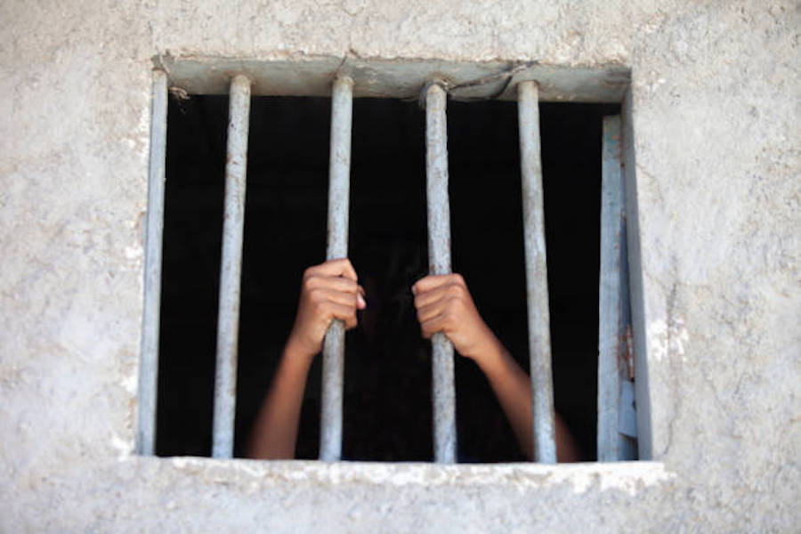 Child Holding Cell Bars